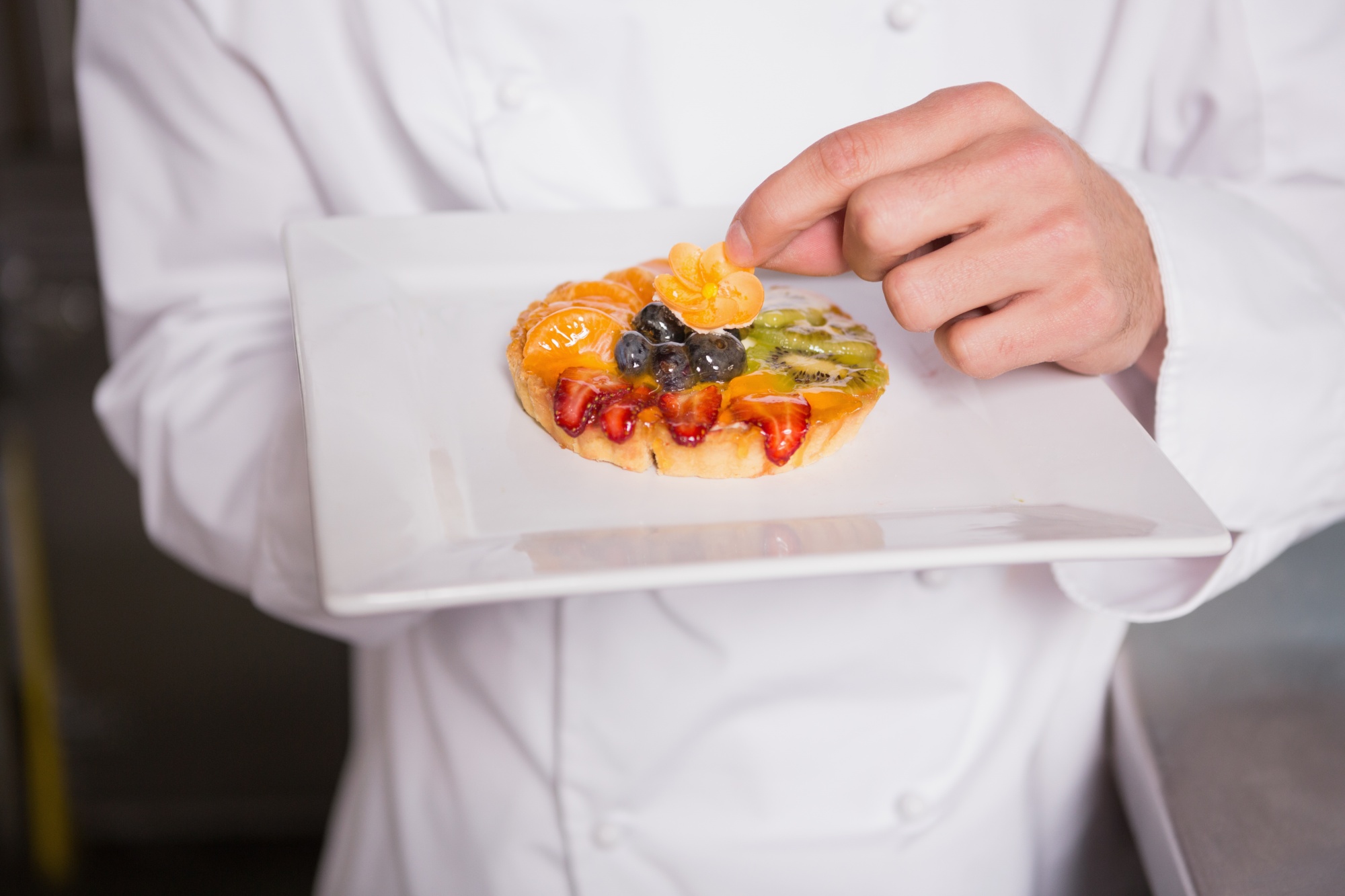 Chef demonstrating portioning technique in a workshop